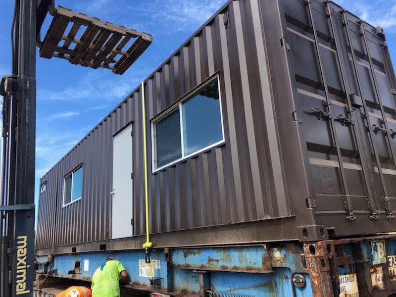 A finished 40ft office loaded on a truck for delivery