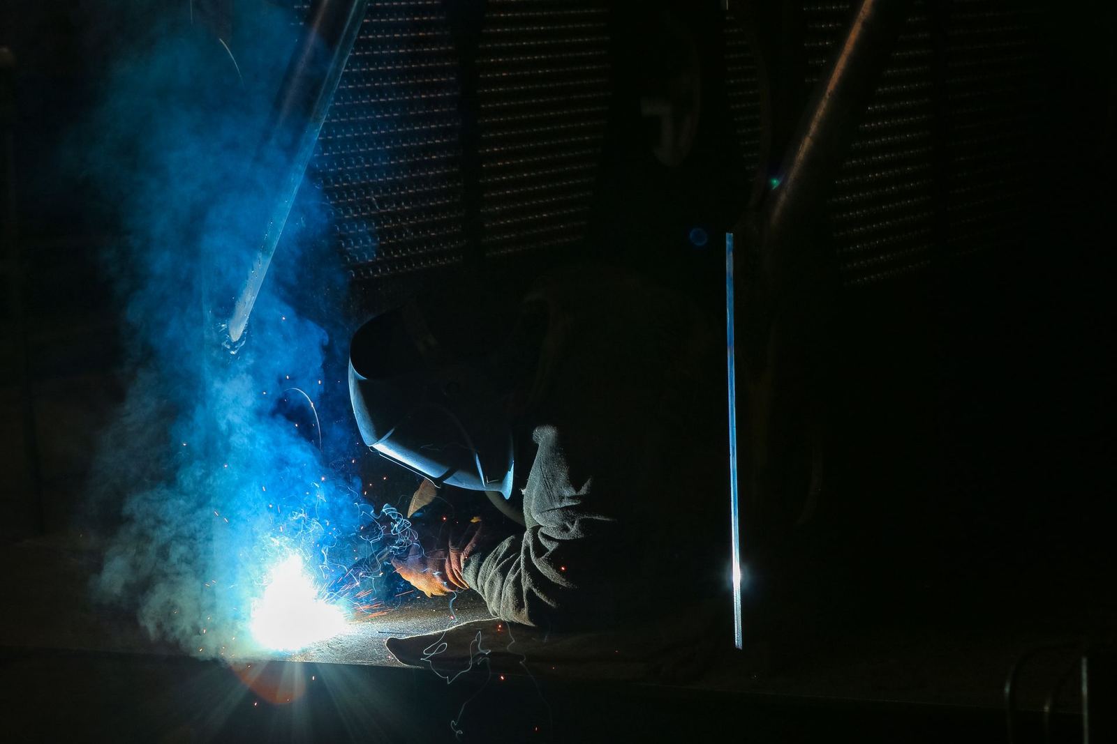 A welder working steel with sparks